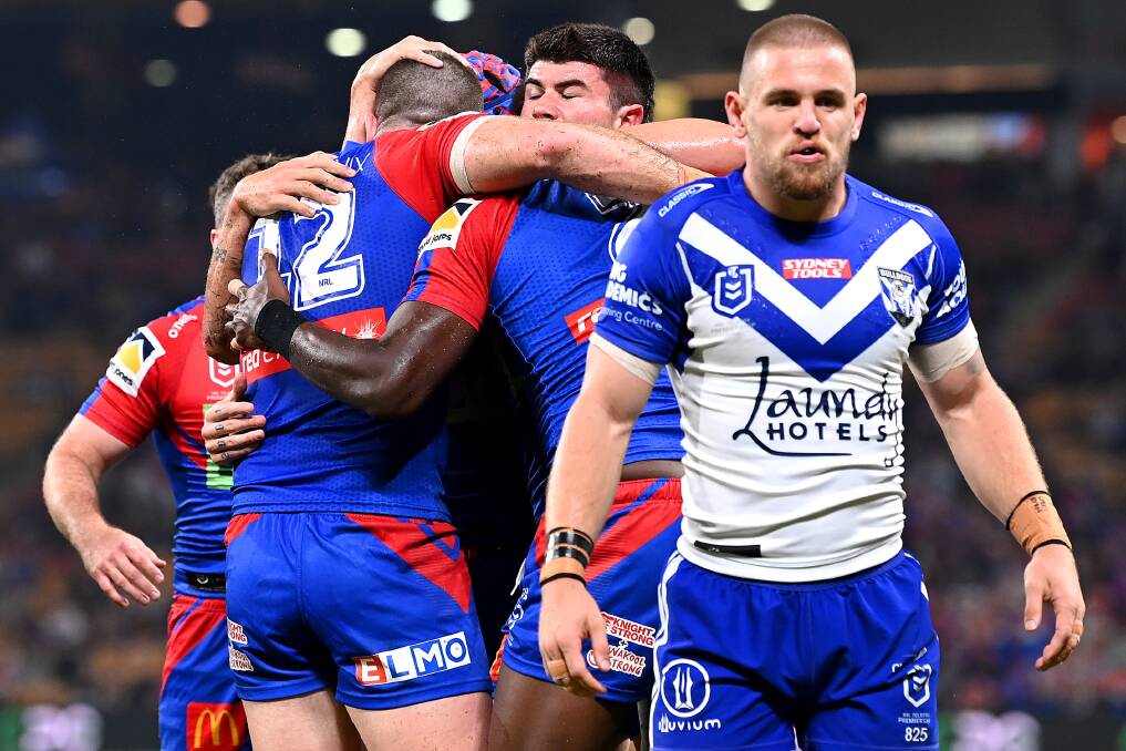 IN FRONT: Knights players celebrate a try behind Bulldogs fullback Matt Dufty. Picture: Getty 
