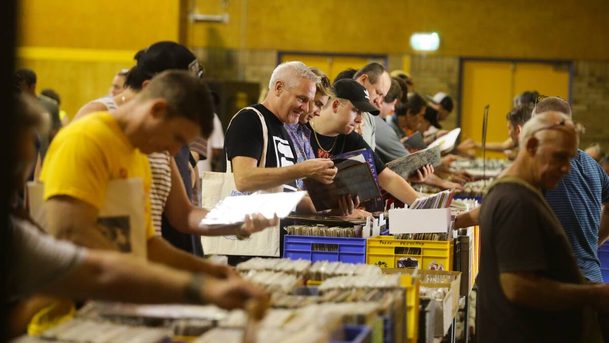SEARCHING: Music lovers at The Hunter Record Fair at Kotara High School on Saturday. The fair is held twice a year and is on again in September. Picture: Jonathan Carroll. 