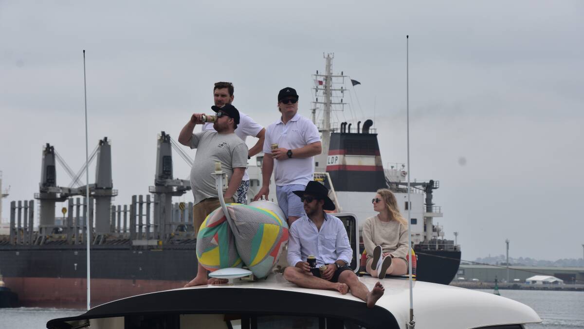 VIEWS: A group of boaties on top of a vessel. 