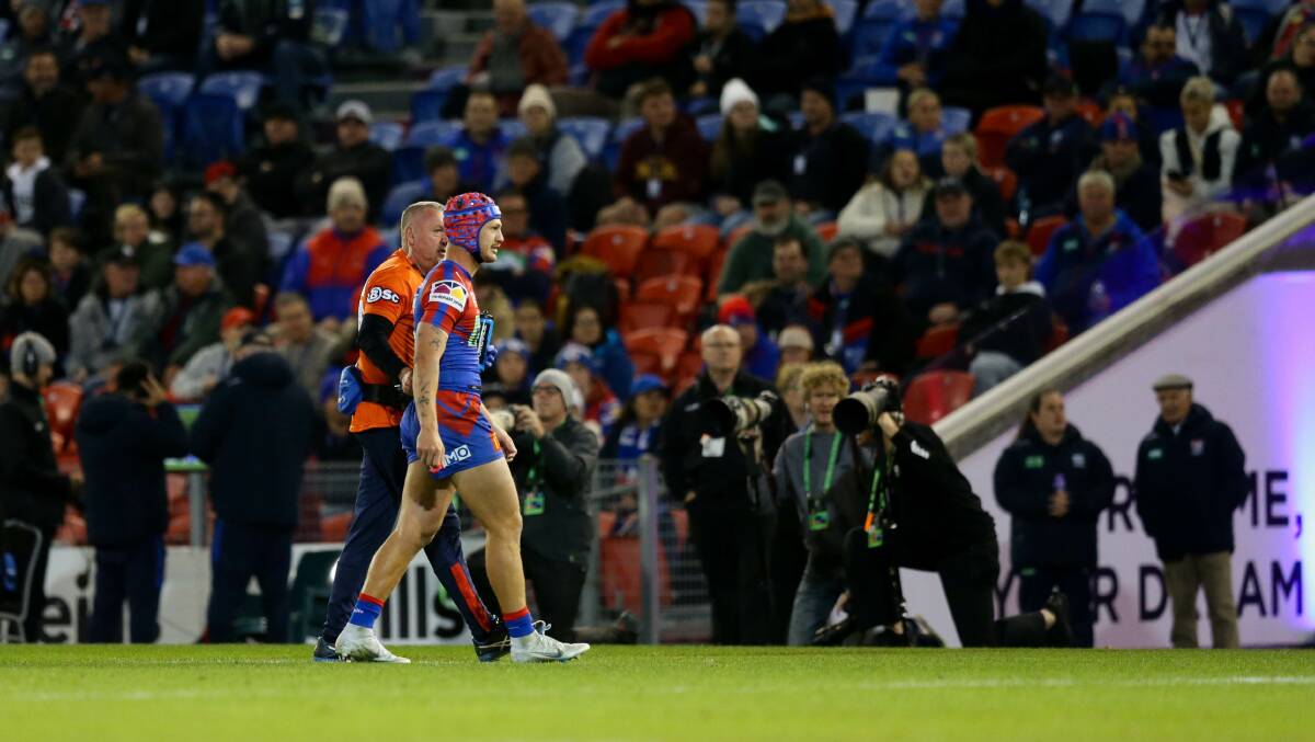 OUT OF ACTION: Newcastle Knights captain Kalyn Ponga leaves the field at McDonald Jones Stadium on Friday night after suffering a head knock eight minutes into the 42-12 loss to Sydney Roosters. Picture: Jonathan Carroll 