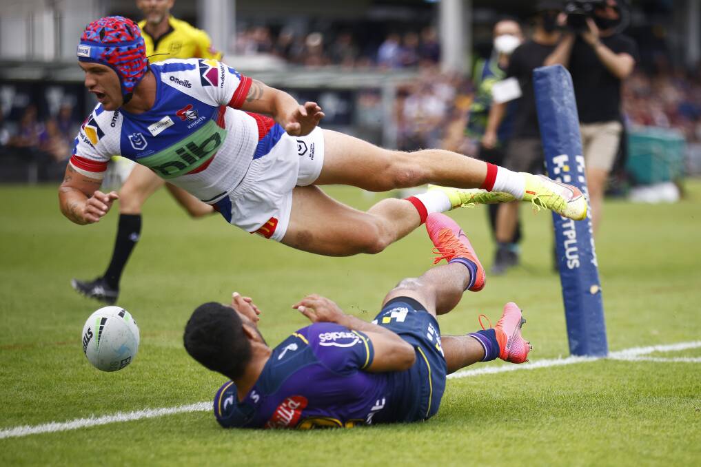 DESPERATE EFFORT: Knights fullback Kalyn Ponga attempts to stop a try. Picture: Getty Images 