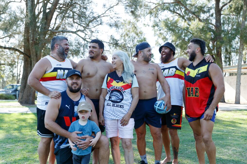 Jacob Briggs, Isaac Briggs (crouched at front), Callan Briggs, Scott Briggs, Jordan Hammond and Randall Briggs, with family matriarch Carol Widders (centre) gathered for All Blacks training this week. Picture by Max Mason-Hubers