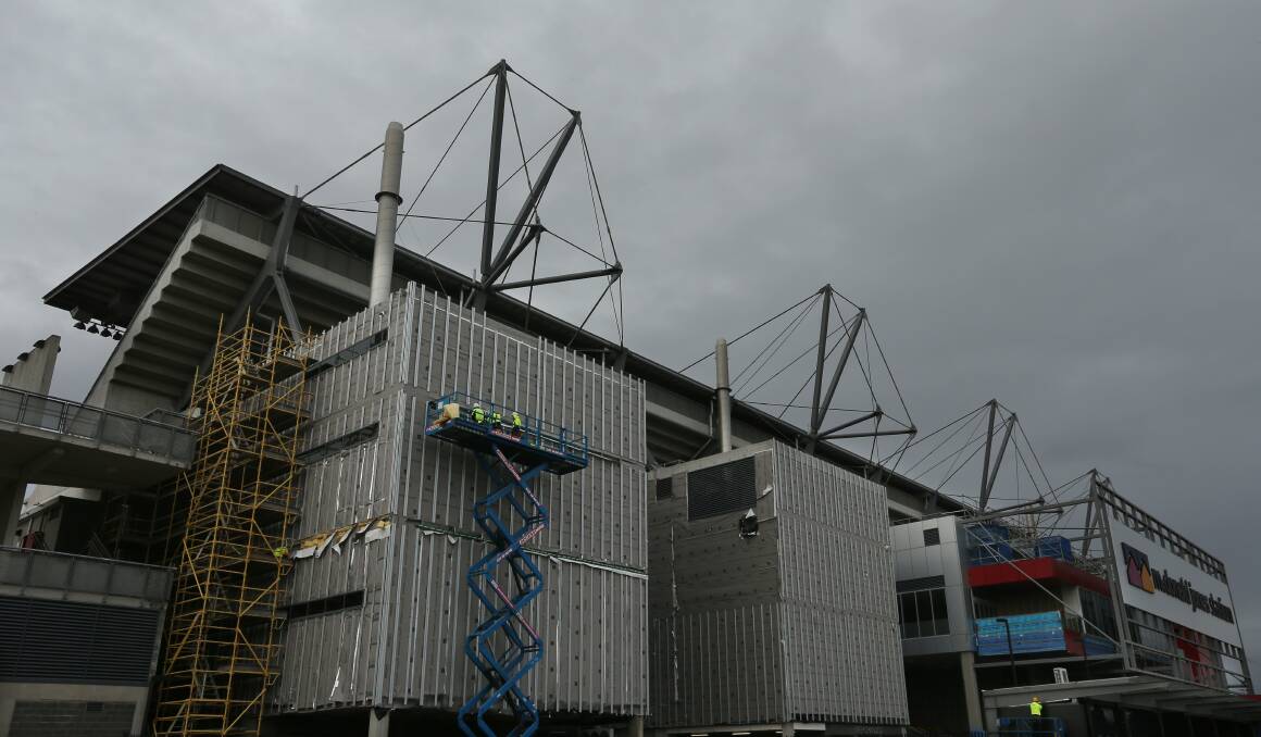 WORKS: McDonald Jones Stadium's western grandstand has been stripped of its external cladding ahead of the installation of a safer product. Picture: Simone De Peak