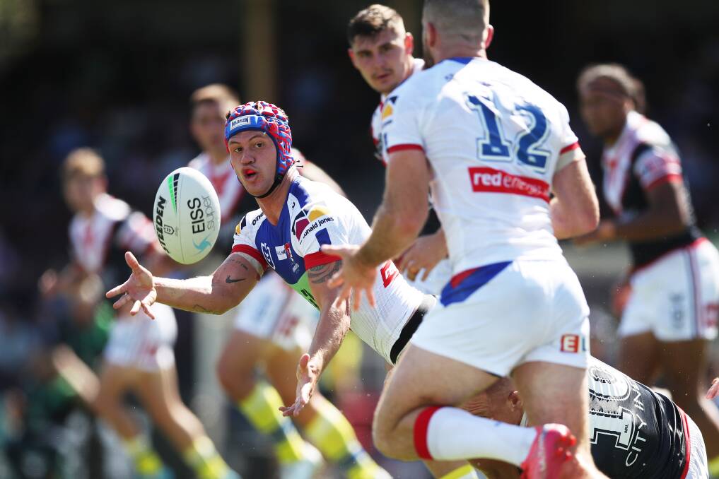 BREAK: Kalyn Ponga gets a pass away to Lachlan Fitzgibbon. Picture: Getty 