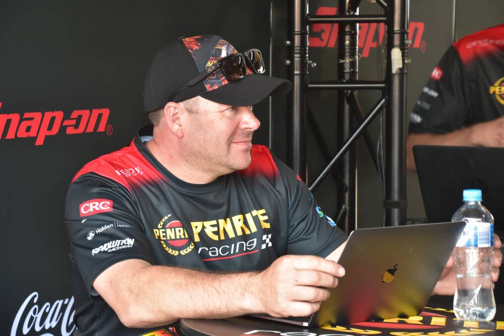 HARD WORK: Barry Ryan on his laptop in pit-lane. 