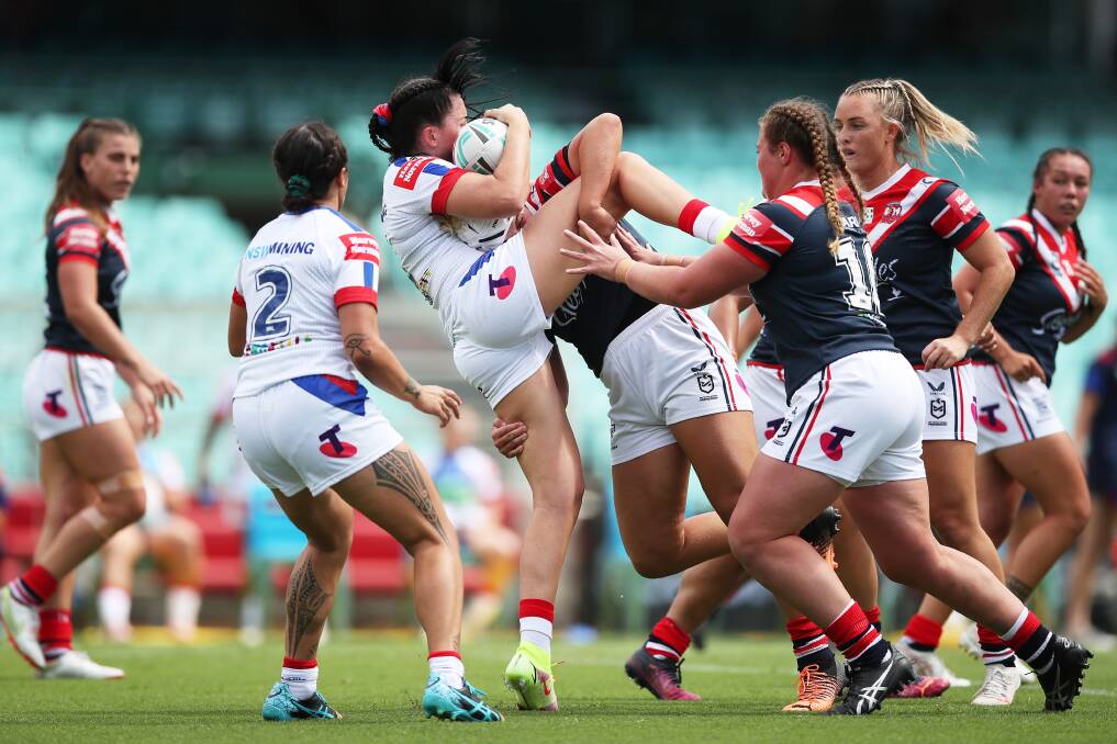 Knights captain Romy Tetizel being tackled by Roosters players on Saturday. Picture: Getty 
