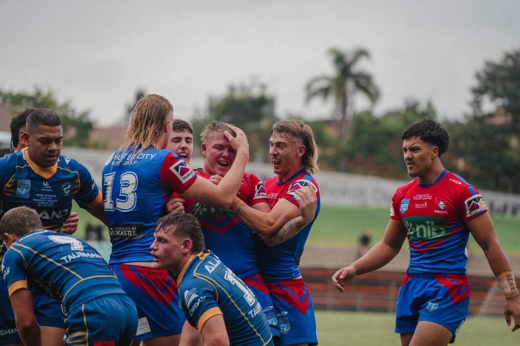 Knights SG Ball players celebrate Beau Slade's first-half try in the grand final on Saturday. Picture by James Ward, Newcastle Knights