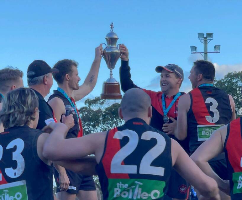 Killarney Vale coach Corey Shackleton, right, and his players celebrate their grand final victory on Saturday. 