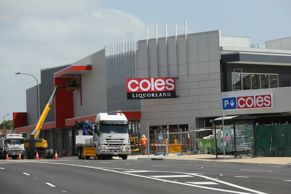 CHANGE: The final touches being added to the Coles supermarket development on Friday. The retail centre has been planned for years and will finally open next month. 