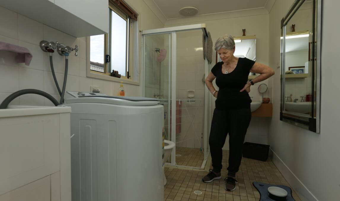 CONCERNS: Ms Black in her bathroom which needs repairs. Picture: Simone De Peak