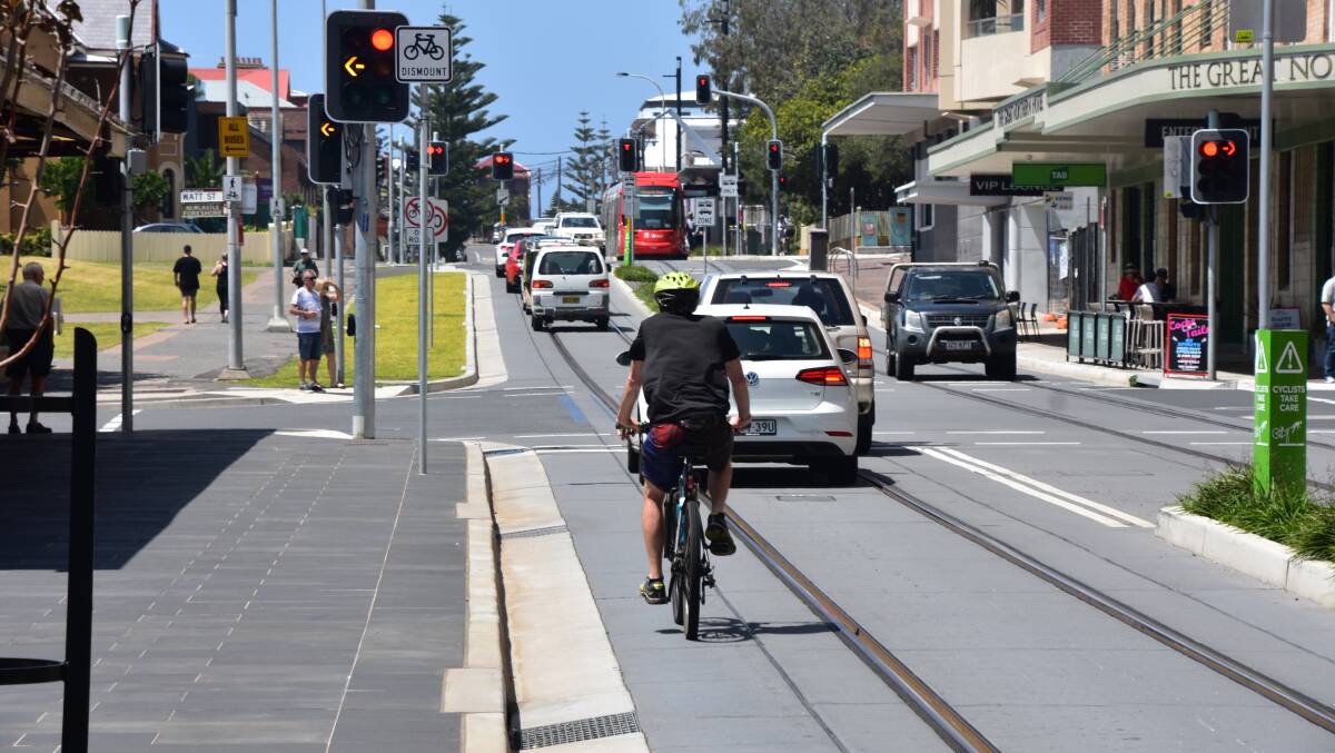 BANNED: A cyclist riding in the mixed-running section of the Newcastle light rail line. Picture: Max McKinney