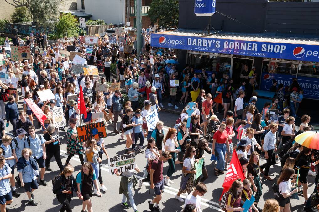 ACTION: Thousands walk along a closed Darby Street during Newastle's School Strike 4 Climate on Friday.