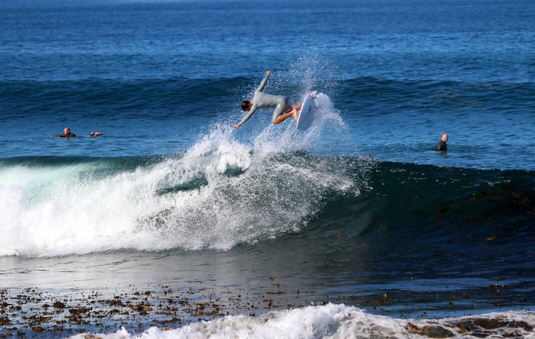HANG TIME: A surfer in Newcastle on Sunday. Picture: Dave Anderson 