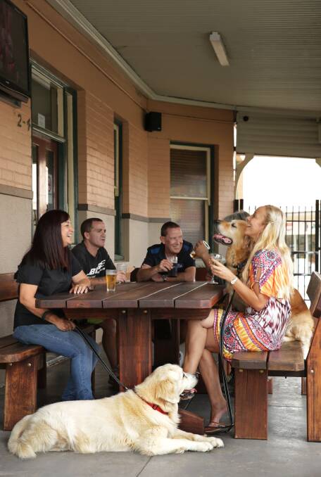 WELCOME: Commercial Hotel owner, Dalila Pestana, and Nikki Taylor from the AHA with her dogs, Max and Sam (laying) in the beer garden. Picture: Simone De Peak. 