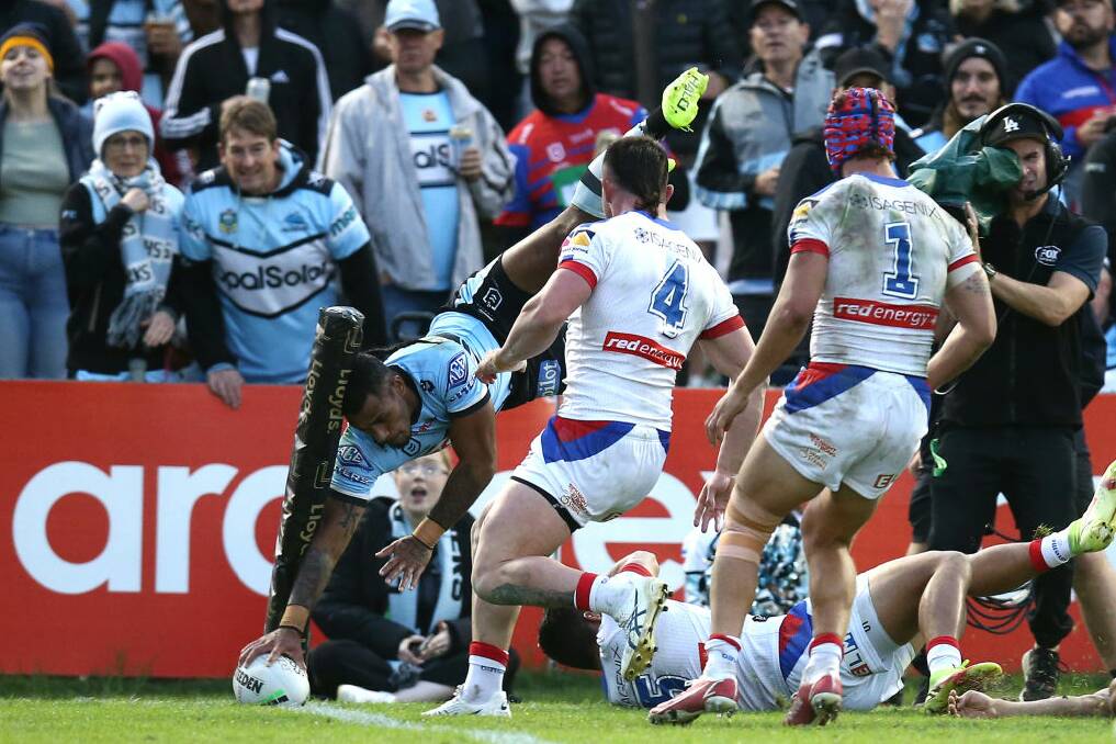 HIGH FLYER: Cronulla winger Sione Katoa scores his side's second try. Picture: Getty Images