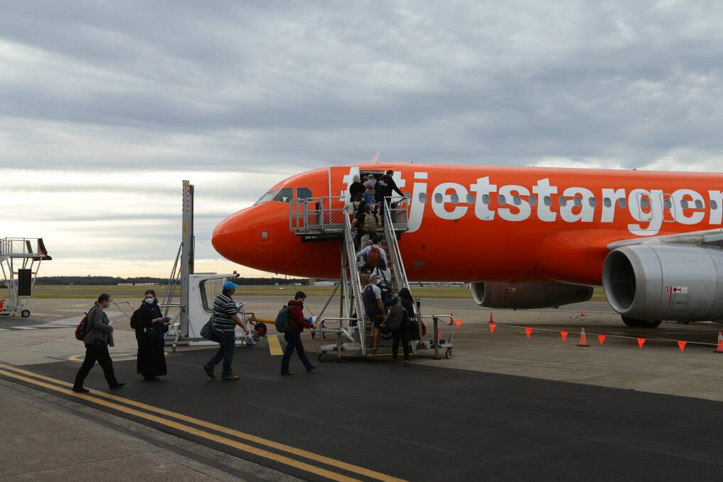 UP AND AWAY: Passengers board the first Jetstar flight to Cairns in June. 