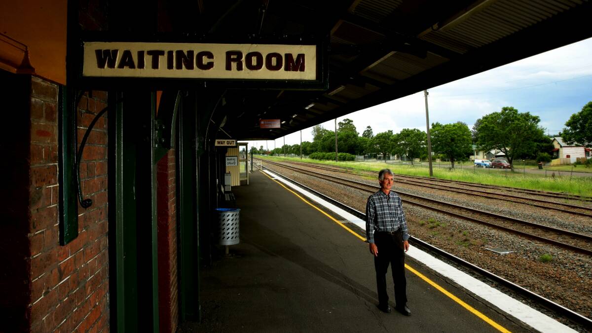 HARD WORK: Martin Fallding from the group called 'Two More Trains For Singleton' on the platform at Singleton train station in 2015. Picture: Peter Stoop