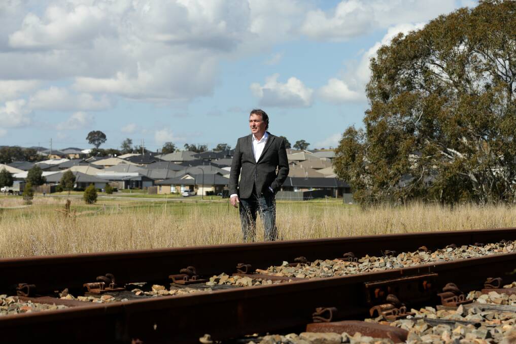 COMMUTER PROXIMITY: Geoffrey Rock, the Urban Development Institute of Australia's Hunter chapter chair, alongside the rail line adjacent to new housing in Gillieston Heights. Read his Opinion piece on page 43. Picture: Jonathan Carroll 