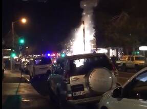 SPARKS FLYING: A power pole in Darby Street on Saturday night explodes. Hundreds were forced to evacuate the immediate area during the peak of dinner service. 
