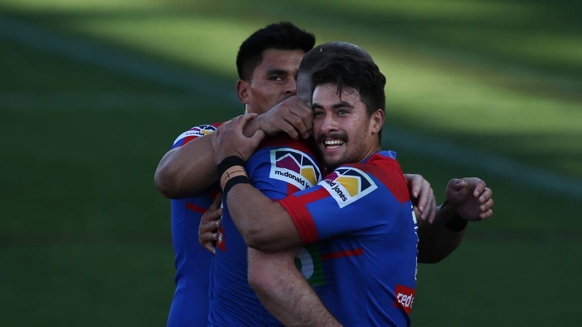 TIGHT GROUP: Tuala celebrates a try with Knights teamamtes. 