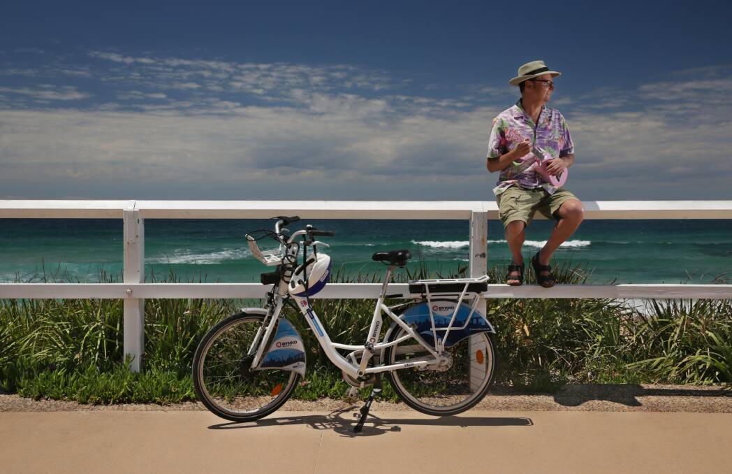 GOOD TIMES: Mark Jackson at Merewether with one of the bikes he uses. Picture: Simone De Peak 