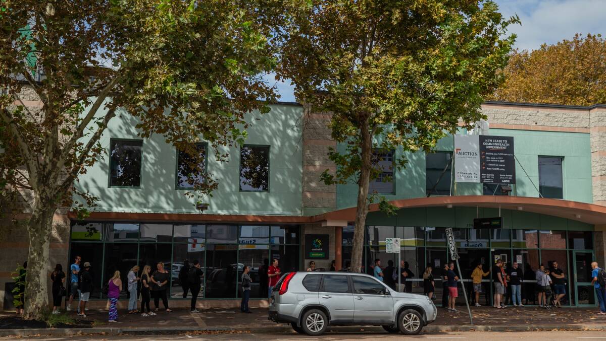 PLAN TO MOVE: A line outside the Newcastle Centrelink service centre, which is one of five offices earmarked for be consolidated into a single site, earlier this year. Picture: Marina Neil