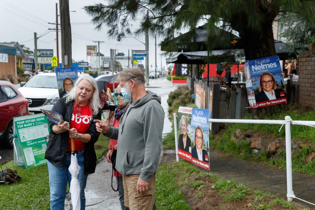 UNDERWAY: Cr Carol Duncan explaining how to vote Labor outside the Adamstown pre-poll centre on Monday. Picture: Max Mason-Hubers 