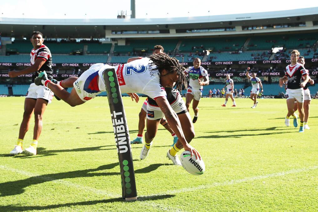 TRY TIME: Knights winger Dom Young dives over in the corner to score his side's fourth and final try against the Roosters at the Sydney Cricket Ground on Saturday afternoon. Young was just as impressive in defence. Picture: Getty