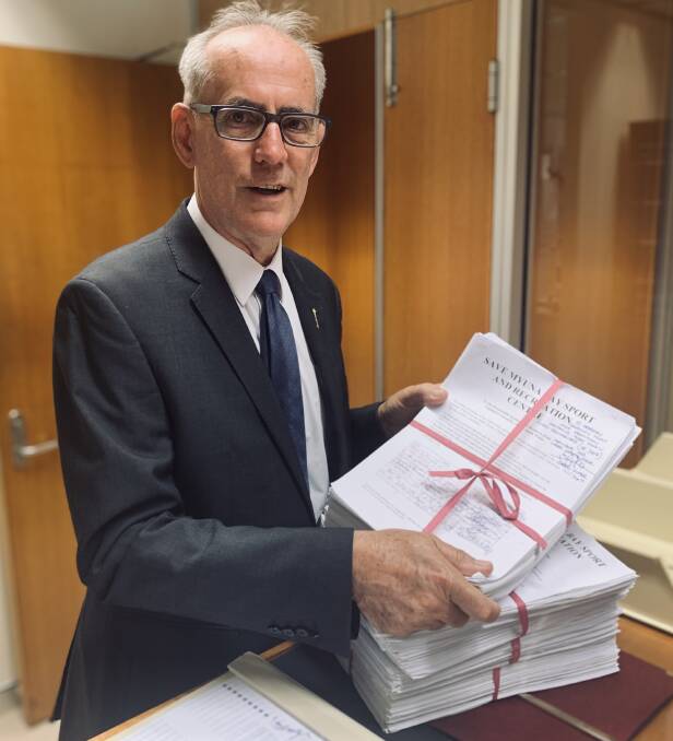 SUPPORT: Lake Macquarie MP Greg Piper presenting his petition of more than 18,000 signatures in state parliament on Tuesday. 