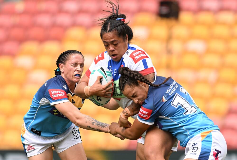 SOLID EFFORT: Knights prop Annetta Nu'uausala carts the ball up against the Titans. Picture: Getty Images 