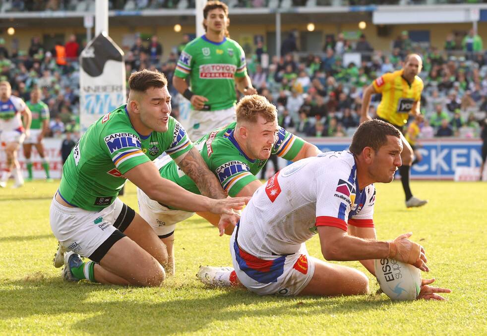 BACK IN THE GAME: Knights forward Mat Croker beats Raiders players to score his first NRL try at GIO Stadium on Sunday. Picture: Getty Images 