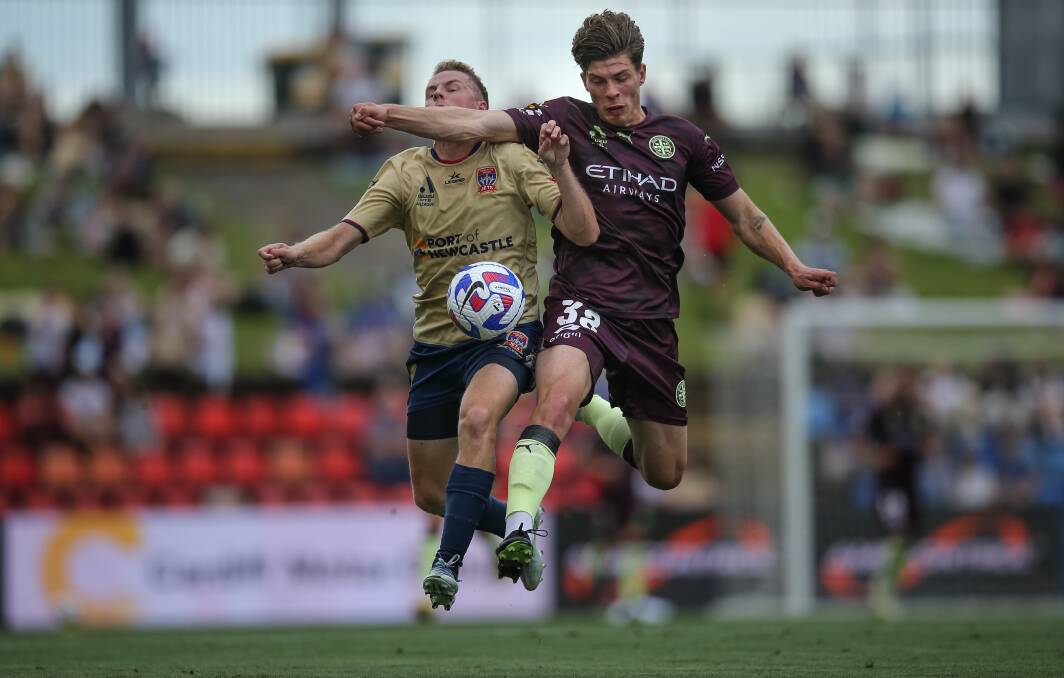 City defender Jordan Bos fends off Newcastle's Trent Buhagiar. Picture by Marina Neil