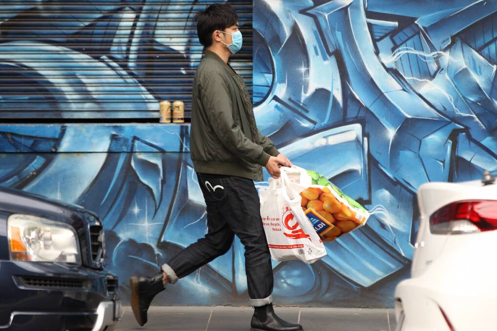 ADVICE: A Melbourne man wearing a mask after shopping. 