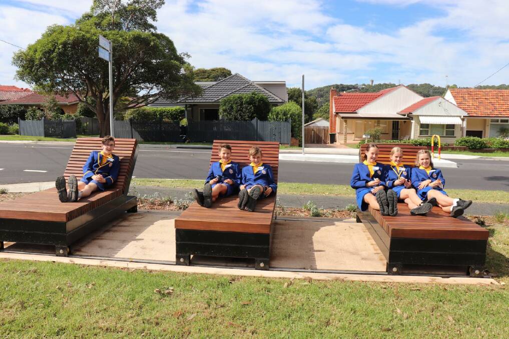 PUBLIC SPACE: Students from Kotara South Public School sitting on new furniture in Joslin Street, Kotara, which underwent a $2.4 million overhaul. Pictures: Supplied