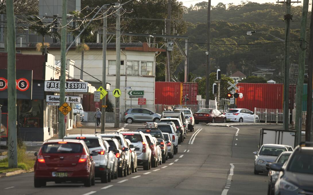 LONG WAIT: Traffic backed up at the Adamstown railway crossing. A freight rail bypass between Fassifern and Hexham would remove the majority of freight trains from the line through suburban areas. Picture: Marina Neil