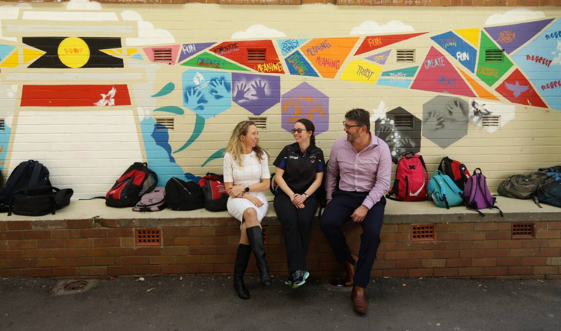 INNOVATION: Callaghan College head teacher of teaching and learning Stacy Lambert, student Keely Harris, and principal Paul Taylor. Picture: Jonathan Carroll