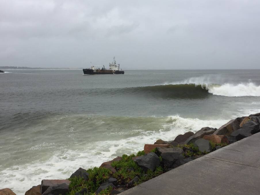 SURF'S UP: Waves breaking at Nobbys breakwall on Monday. Picture: Ian Kirkwood