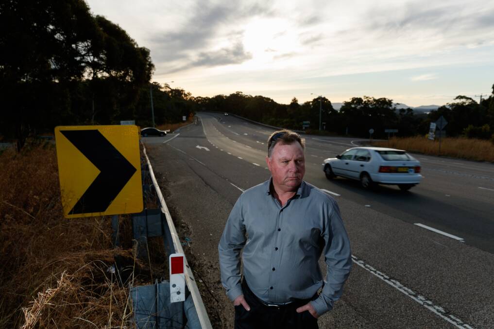 CONCERNED: Lake Macquarie east ward councillor John Gilbert at the Pacific Highway, Flowers Drive and Cams Wharf Road intersection, which be believes should have traffic lights and four-way access. Picture: Max Mason-Hubers