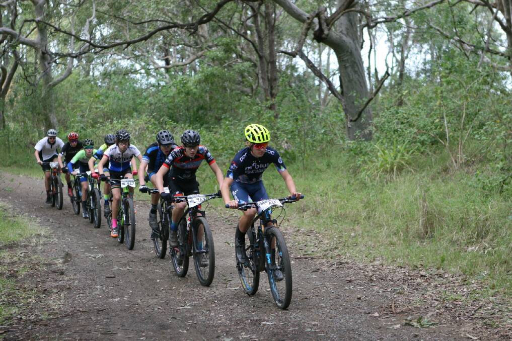 POWERING AHEAD: Macquarie College student Owen Tooley leads a pack of riders in the under-17 men's race. Pictures: Supplied