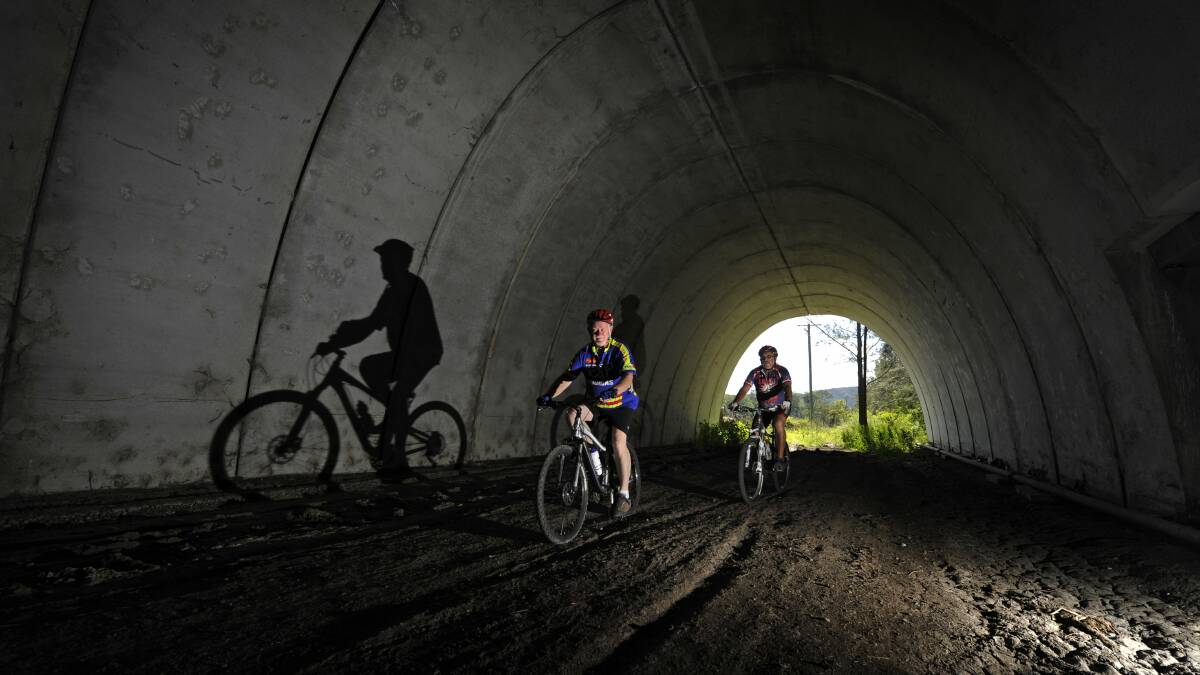 FRESH LIGHT: Cyclists David Atkinson and Billy Metcalfe during a ride through a tunnel on part of the planned Richmond Vale Rail Trail route in 2013. There are three tunnels on the proposed route. Picture: Marina Neil