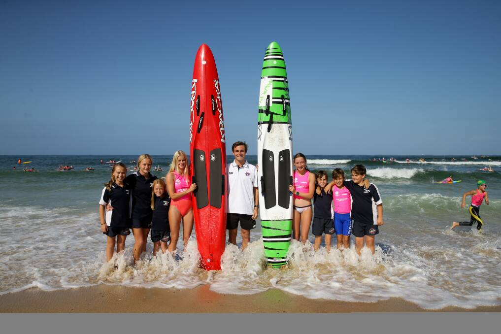 READY TO GO: Dan Collins, centre, with nippers (from left) Macy, Lani and Evie Waller, Zara Foran, Mayla and Tayn Cotterell, Tyler Clark and Egan Cotterell at Blackmsiths beach on Thursday. Picture: Jonathan Carroll