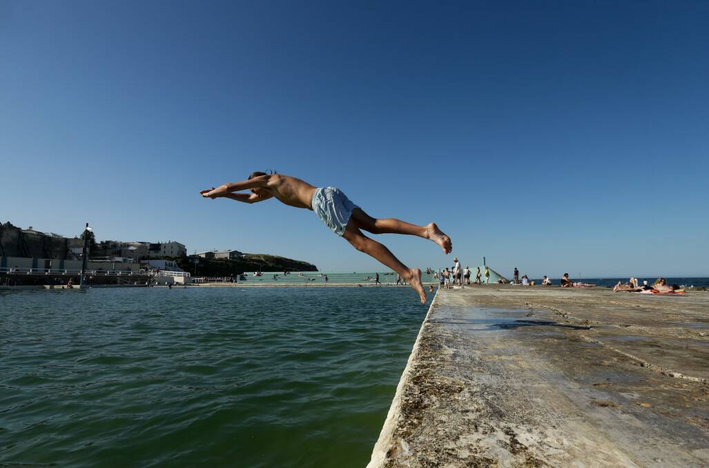 A man leaping into the pool last year. A new pool deck will be installed and will be between 20 and 30 centimetres higher than the existing surface. Picture: Jonathan Carroll