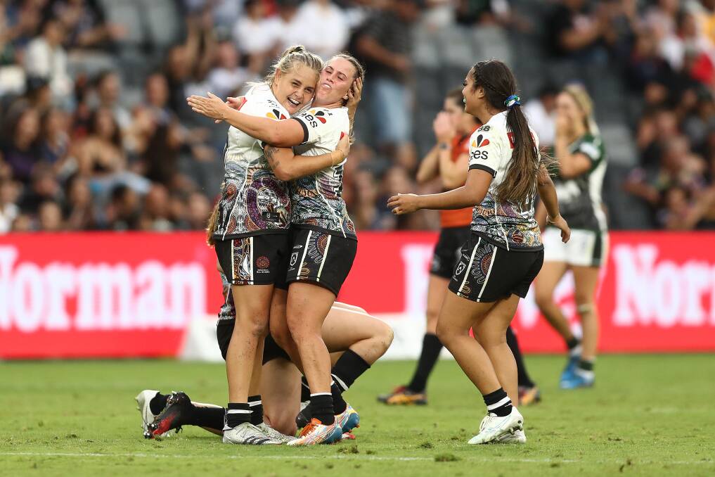 COACH'S PRAISE: Knights NRLW forward Caitlan Johnston, left, celebrating the Indigenous side's victory in the All Stars match on Saturday night. Her club coach Casey Bromilow thought she was best on ground. Picture: Getty Images 