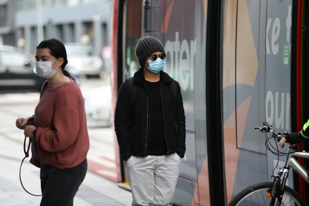 CAUTION: Tram passengers wearing masks at Newcastle Interchange on Tuesday. Pictures: Jonathan Carroll