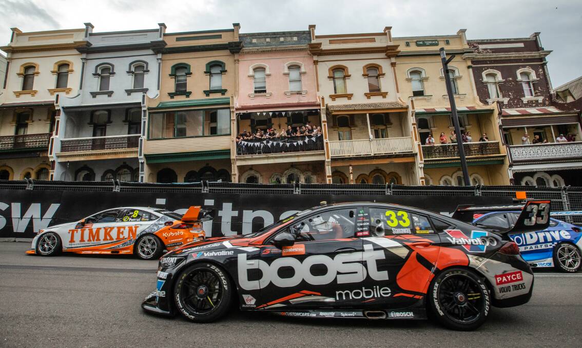 Race cars drive past historic terrace homes in Watt Street, Newcastle. File picture 