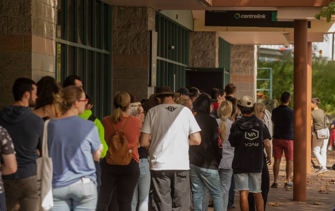 DEMAND: The line outside the Centrelink service centre on King Street in Newcastle on Monday morning. There were similar scenes outside the Charlestown, Wallsend and Maitland centres. Picture: Marina Neil