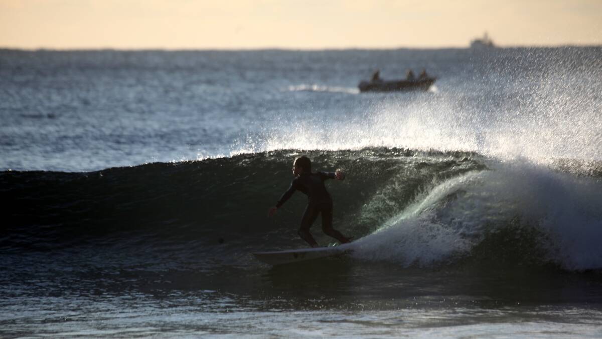 STYLE: A surfer in Newcastle on Monday. Picture: Dave Anderson