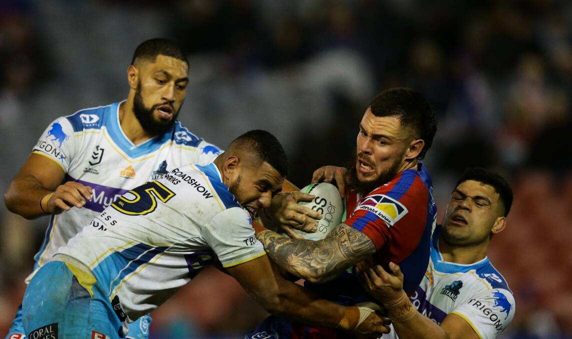 TOUGHER TASK: Knights prop David Klemmer being tackled by Titans players during Newcastle's 38-12 win over the Gold Coast in July. Picture: Jonathan Carroll 