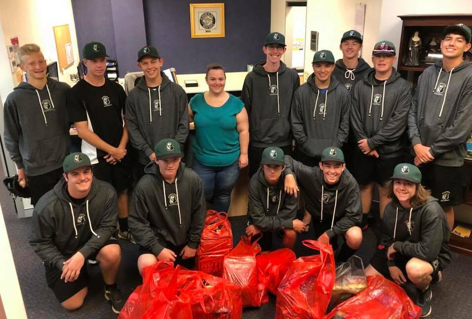 KIND: Some of the Newcastle Eagles baseball side with their food donation. 