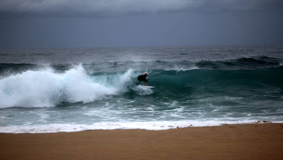 SLIM PICKINGS: A man rides shorebreak on Wednesday. Picture: Dave Anderson